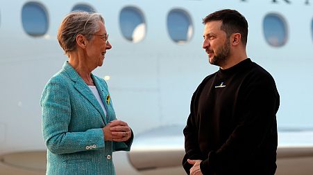 Ukrainian President Volodymyr Zelenskyy is welcomed by French Prime minister Elisabeth Borne upon his arrival at Villacoublay Air Base, southwest of Paris, 14 May, 2023