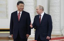 China's president Xi Jinping and Russia's president Vladimir Putin walking side by side.