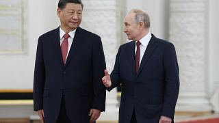 China's president Xi Jinping and Russia's president Vladimir Putin walking side by side.