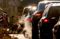 Cars give off exhaust fumes as children head to school in Frankfurt, Germany.