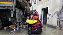 Firefighters rescue an elderly man in the flooded village of Castel Bolognese, Italy, Wednesday, May 17, 2023. 