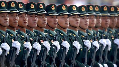 Chinese People's Liberation Army soldiers march in formation during a parade to commemorate the 70th anniversary of the founding of the People's Republic of China in Beijing