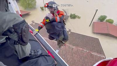 rescuers saving a man from the roof of a flooded house, in the area of the town of Faenza in the northern Italian region of Emilia Romagna, Wednesday, May 17, 2023.
