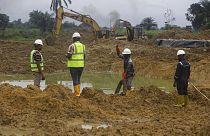 Workers use caterpillars to excavate contaminated soil caused by oil spills into bio-cells for treatment, in Bera-Alue, in Nigeria Delta, Oct. 9, 2021