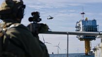 A sniper provides fire cover during a COASTEX security exercise at a wind farm in the North Sea, Belgium 