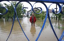 A Bosnian man stands in flooded water in front of his house in the village of Janja, near northern Bosnian town of Bijeljina, 130kms north east of Sarajevo.