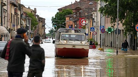 Firefighters arrive in the flooded village of Castel Bolognese, Italy, Wednesday, 17 May.