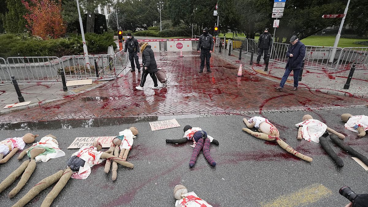 Dummies covered in red paint were placed on a street in Poland to signify women suffering due to abortion restrictions during a protest in Warsaw. 30 November 2021