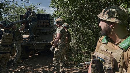 Ukrainian soldiers load rockets into a Grad multiple rocket launcher near Bakhmut, Donetsk region, Ukraine, Wednesday, May 17