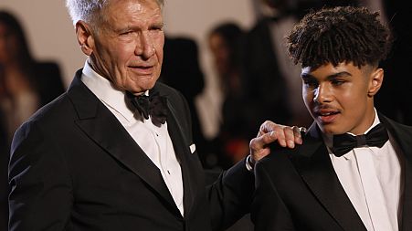 Harrison Ford and Ethann Isidore pose for photographers in Cannes