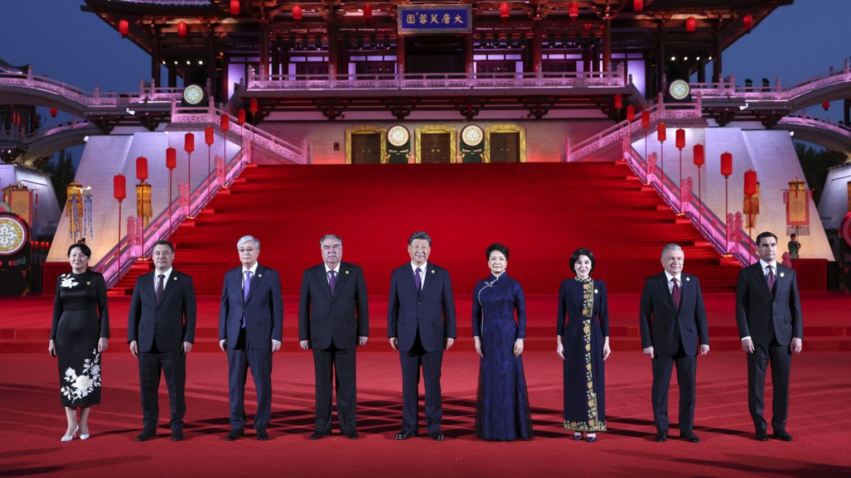 In this photo released by China's Xinhua News Agency, Chinese President Xi Jinping, center, and his wife Peng Liyuan, forth right, pose for a photo with Central Asian leaders.