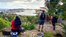 People look out toward the seafront from the Vierge du Pacifique in Noumea on May 19, 2023, after an earthquake hit the island.