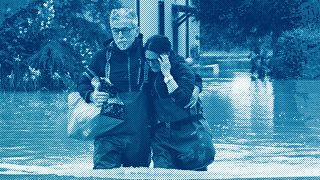 A couple walk in a flooded road of Lugo, Italy, 18 May 2023