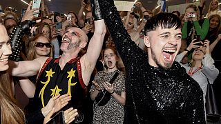 Rapper Kaarija of Finland (R) greets his supporters after arriving from the Eurovision Song Contest 2023