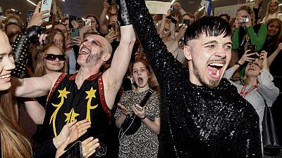 Rapper Kaarija of Finland (R) greets his supporters after arriving from the Eurovision Song Contest 2023