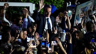 Greece's Prime Minister and leader of New Democracy Kyriakos Mitsotakis, center, addresses supporters at the headquarters of his party in Athens, Greece, Sunday, May 21, 2023