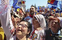 People with European Union flags and placards at a rally in Moldova. 