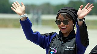 Saudi Arabian astronaut Rayyanah Barnawi waves to family and friends as she arrives at the Kennedy Space Center in Cape Canaveral, Fla., May 21, 2023.
