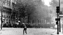 A student throws stones at police in Paris, France, during a student strike in May 1968. 