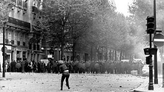 A student throws stones at police in Paris, France, during a student strike in May 1968. 