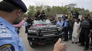 Security personnels clear way for a vehicle carrying the Pakistan's former Prime Minister Imran Khan arrives to appear in a court, in Islamabad, Pakistan, May 23, 20223.