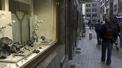 People pass a jewelry store in the diamond quarter in Antwerp, Belgium.