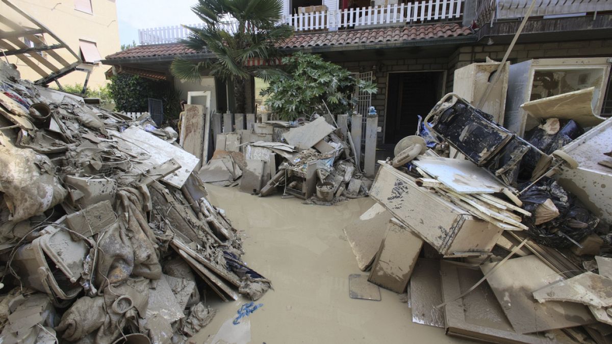 Household goods are piled outside a building after heavy flooding, in Faenza, Italy, Monday, May 22, 2023