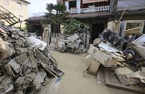 Household goods are piled outside a building after heavy flooding, in Faenza, Italy, Monday, May 22, 2023