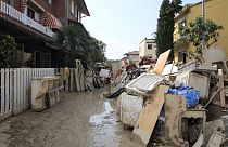 Household goods are piled on the side of a road after heavy flooding, in Faenza, Italy, Monday, May 22, 2023. 