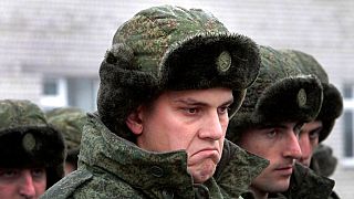 Conscripts stand at a military conscription office in Grozny, Chechnya's provincial capital, Russia, Monday, Nov. 17, 2014. 