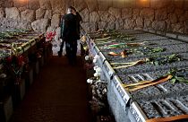A man walks amid the graves of the 335 victims of one of the worst World War II-era massacres in German-occupied Italy at the Ardeatine Caves in Rome, on 24 March 2023. 