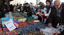 Shoppers browse candy and sweets at a market stall in the historical Ulus district of Ankara, on April 19, 2023.