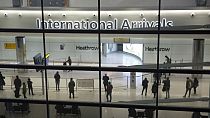 People in the arrivals area at Heathrow Airport in London, Jan. 26, 2021. 