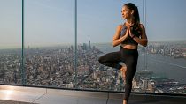 Eine Frau praktiziert Yoga auf der Aussichtplattform eines Wolkenkratzers in New York