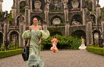 A model wears a creation as part of the women's Louis Vuitton Cruise 2024 collection, unveiled on Isola Bella, Italy.