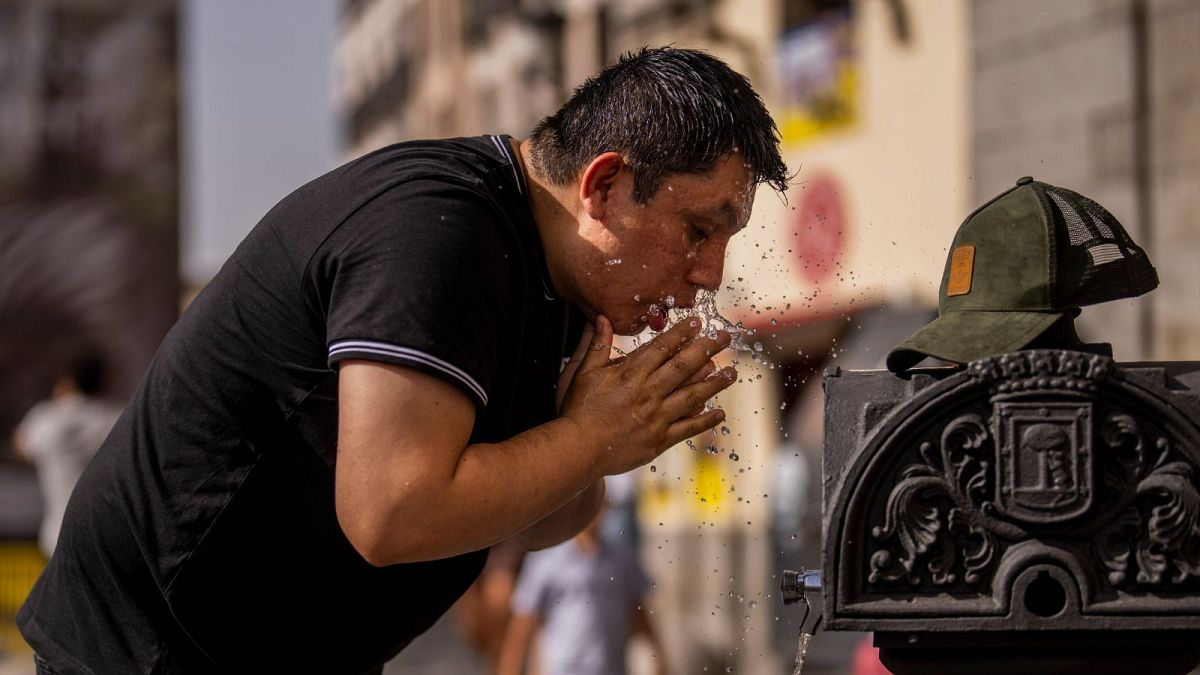 A man cools off in a fountain during a heatwave in Madrid. Is climate change finally becoming a major election issue in Spain? 