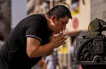 A man cools off in a fountain during a heatwave in Madrid. Is climate change finally becoming a major election issue in Spain?