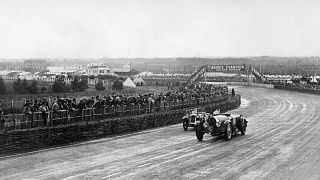 Race cars take the Dunlop Curve, while competing in the 13rd edition of the 24 hours of Le Mans car race, on June 15, 1935 in Le Mans. 