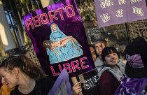 A woman holds a banner reading "free abortion" during a rally to mark International Women's Day in Madrid, March 8, 2019.
