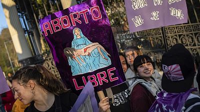 A woman holds a banner reading "free abortion" during a rally to mark International Women's Day in Madrid, March 8, 2019.