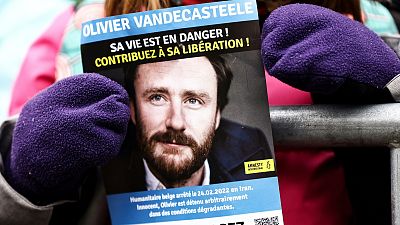 A petition flyer with the portrait of Olivier Vandecasteele in Brussels on January 22. 2023