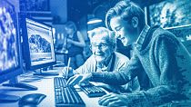 An illustration of a young IT expert helping an elderly person use the computer