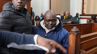 Fulgence Kayishema, center, enters the Magistrate's Court in Cape Town, South Africa