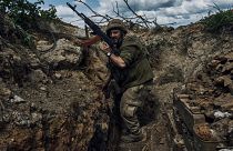 A Ukrainian soldier is seen in a trench at the front line near Bakhmut.