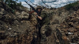A Ukrainian soldier is seen in a trench at the front line near Bakhmut.