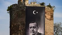 A giant banner of Turkish President and People's Alliance's presidential candidate Recep Tayyip Erdogan is displayed on an historical city wall, in Istanbul, Turkey, Saturday,