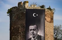 A giant banner of Turkish President and People's Alliance's presidential candidate Recep Tayyip Erdogan is displayed on an historical city wall, in Istanbul, Turkey, Saturday,