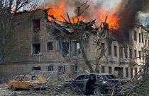 Firefighters hose down a Policlinic following a Russian attack in Dnipro, Ukraine,