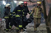 Firefighters carry a body after a Russian attack in Dnipro, Ukraine