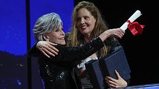 Justine Triet, right, accepts the Palme d'Or for 'Anatomy of a Fall,' which was presented by Jane Fonda, left, during the awards ceremony of the 76th film festival.